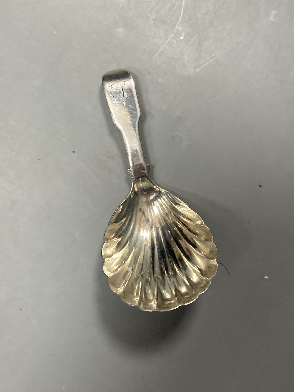 A pair of late Victorian silver pepperettes, London, 1891, 95mm, A George III silver caddy spoon, etc.